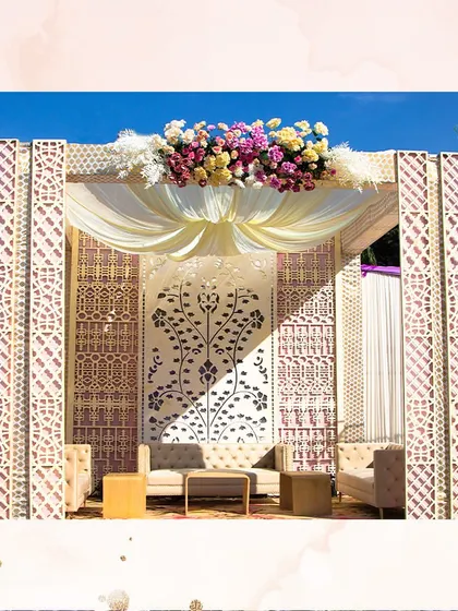 A detailed backdrop and traditional Indian seating create a royal experience. This shamiana setup with fresh flowers is all about the details.