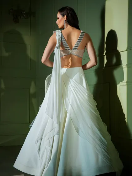 A different angle of the white ruffled gown, highlighting the craftsmanship and unique design.
