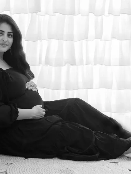 This quiet, contemplative portrait shows the beauty of black and white for solo maternity shots. The focus is entirely on the mother-to-be and the peaceful moment she is experiencing.