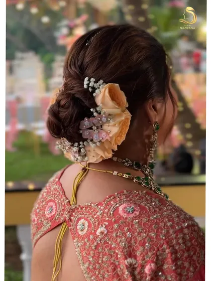 Another view of the butterfly and floral bun, perfect for a daytime wedding or a garden-themed event.