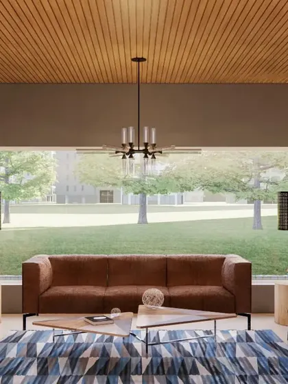 The waiting lounge for the marketing office, designed to feel open and inviting. A large picture window floods the space with natural light and offers an expansive view of the property. The wood-louvered ceiling and sleek furniture create a look of understated luxury.