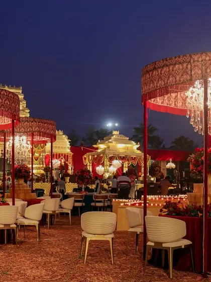 A duplicate of image 70, showing the beautiful dining canopies under the evening sky, with the main mandap visible in the distance.