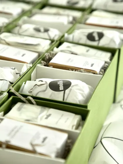 Packing the Rakhi gift boxes, each item carefully placed and wrapped.