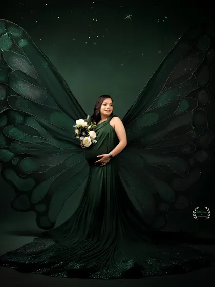 A truly unique and artistic portrait, with giant green butterfly wings transforming the mother-to-be into a mythical, beautiful creature.