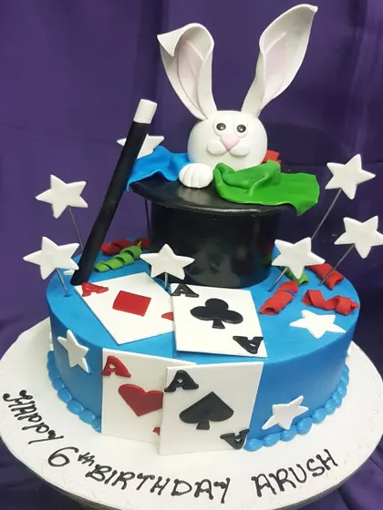 Abracadabra! This magician-themed cake is full of tricks, with a rabbit popping out of a hat and a fan of playing cards. It's a magical choice for a 6th birthday party.