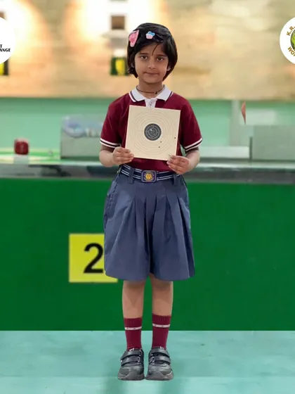 One of our youngest shooters proudly holding up her target. We make learning safe and accessible for everyone.