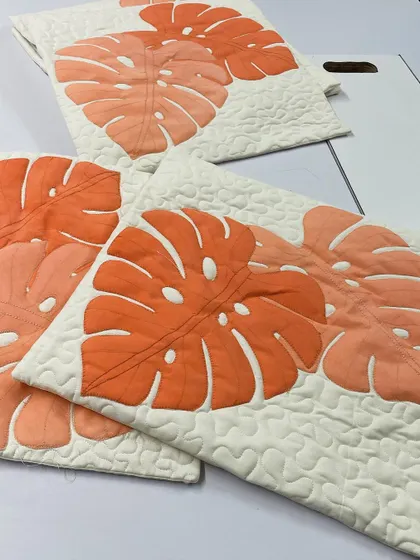 The set of Monstera leaf cushion covers, ready to brighten up a sofa.
