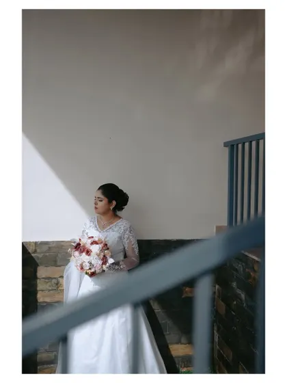 A variation of the previous shot, framed through a railing. This composition adds depth and a sense of looking in on a private, beautiful moment.