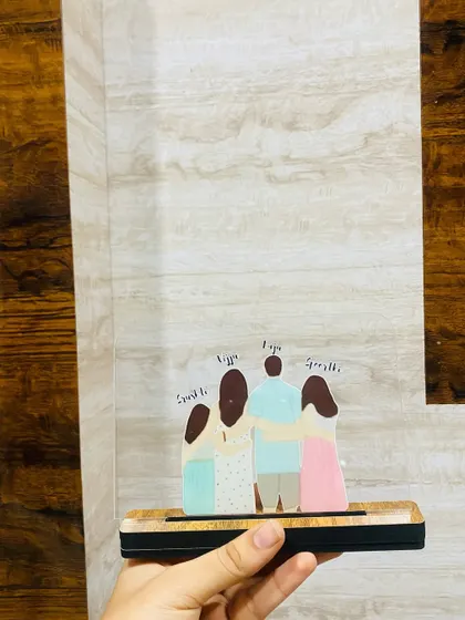 The family acrylic standee displayed against a textured wall. This shows how it can fit into different home environments, adding a personal and modern touch to your decor.