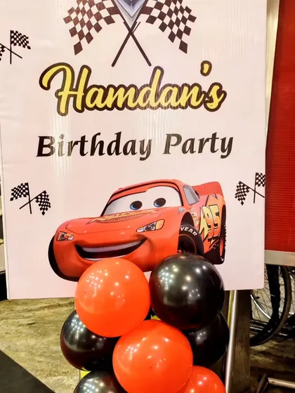 A personalized welcome sign for Hamdan's Cars-themed birthday party, featuring Lightning McQueen.