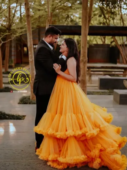 A romantic dance pose. The groom's simple and elegant suit is the perfect counterpart to the bride's elaborate and colourful gown.