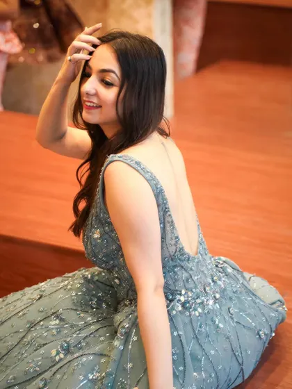 A candid, happy moment in the gorgeous grey ball gown. The backless design adds a touch of modern glam to this fairytale dress.