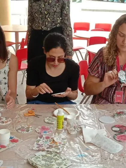 Participants at our Mother's Day decoupage workshop, focused on creating their beautiful coasters.