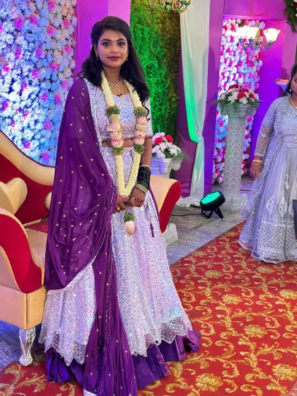 Our client looking lovely at her reception in a shimmering lavender and purple lehenga. This rental piece is perfect for dancing the night away.