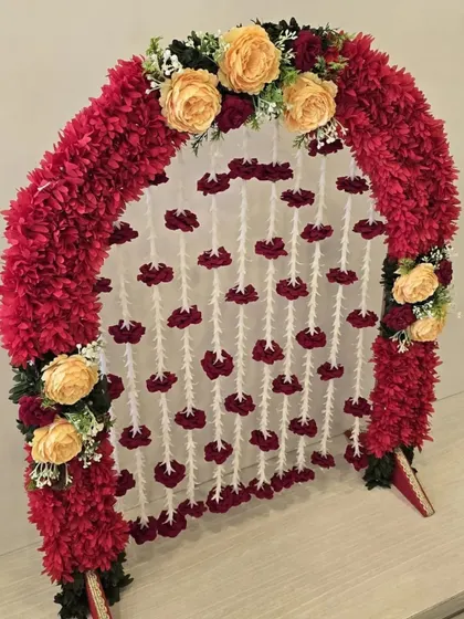 A vibrant and traditional small arch, perfect for home pujas. The red and yellow combination is classic and festive.
