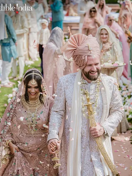 My photograph of a couple's joyful walk through a shower of petals, featured by Incredible India to promote royal weddings in Jaipur.
