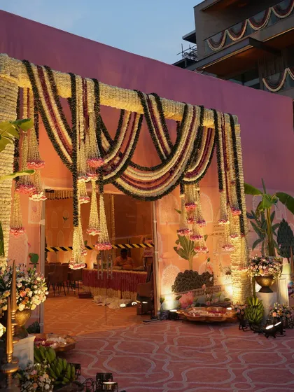 Another view of the stunning floral entrance arch, showcasing its scale and the intricate work involved in its creation. It serves as a beautiful gateway for a traditional wedding celebration.
