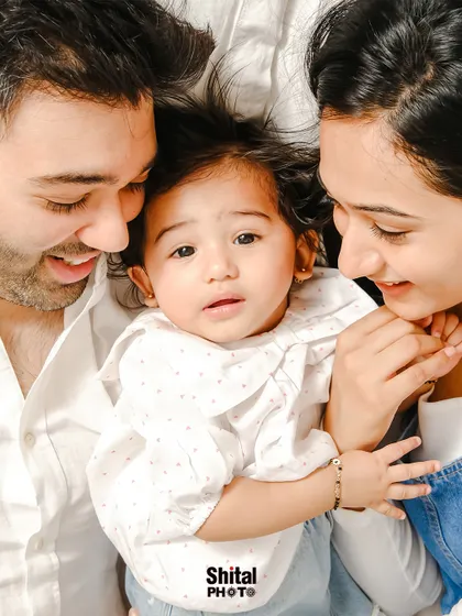 An intimate, top-down view of a family sharing a quiet moment. This unique angle creates a feeling of being enveloped in love.