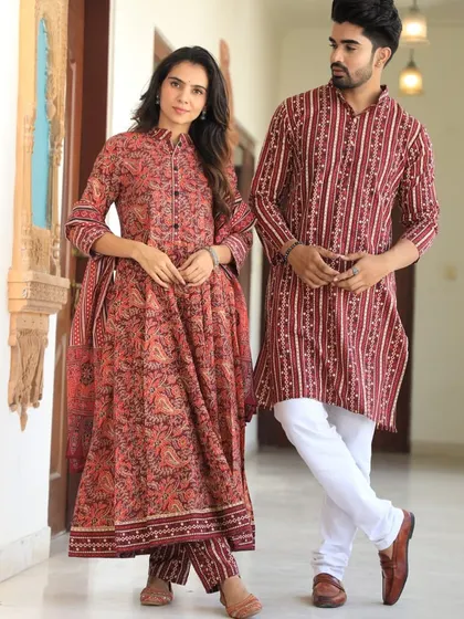 A striking red and indigo couple's set with a mix of paisley and striped prints. The Anarkali features a collared neck for a touch of sophistication.