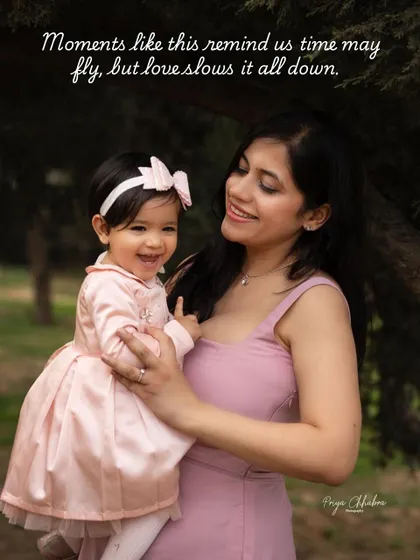 Moments like this remind us that while time may fly, love slows it all down. A mother's gentle hold and a shared smile with her daughter during her first birthday outdoor shoot.