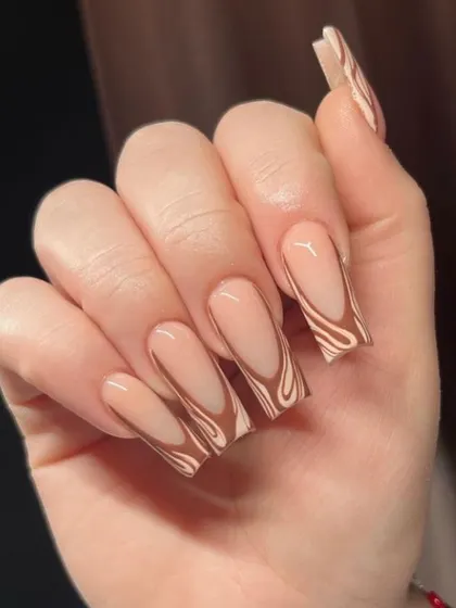 A trendy 'latte swirl' design on long coffin nails, with abstract brown and nude patterns for a chic, modern look.