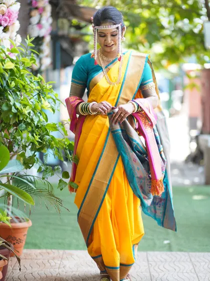A full-length shot of the bride, capturing the elegance of her posture and the beauty of her traditional attire.
