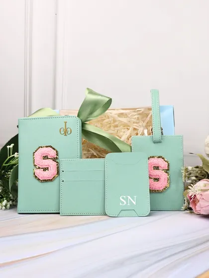 The mint green travel combo, featuring a personalized passport cover, card holder, and luggage tag. It's a stylish and practical gift for any sibling.