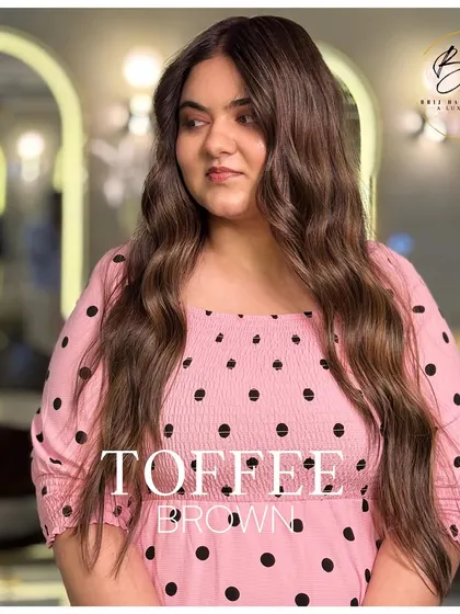 The client's happy and confident look says everything about her new toffee brown hair. It's a shade that's both rich and subtle.