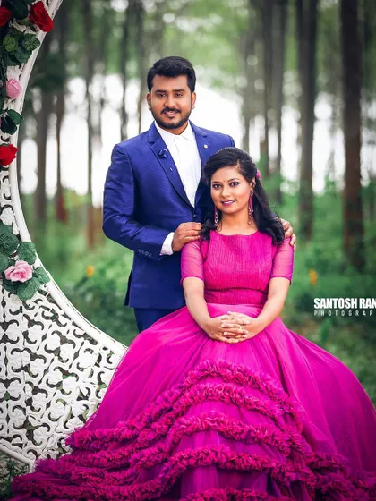 A beautiful outdoor portrait of a couple in formal wear, set against a backdrop of trees.