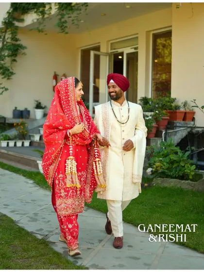 Ganeemat and Rishi in a candid walking shot after their wedding. The groom's smile shows the pure joy of the moment, perfectly capturing the post-ceremony bliss.