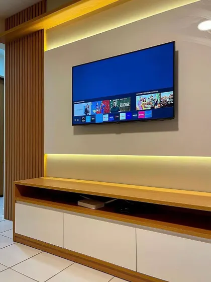 An angled view of the simple yet elegant TV unit, highlighting the clean lines and the combination of open and closed storage.