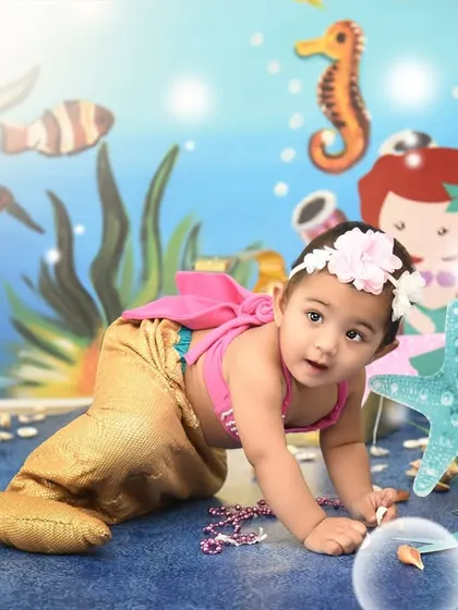 Crawling through her underwater kingdom. The mermaid theme allows for so many cute and imaginative poses.