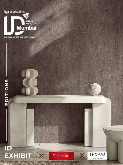Another promotional graphic for Texam at India Design. This image features a deeply textured, dark wallcovering that adds a sense of drama and sophistication to a modern entryway, showcasing the brand's focus on tactile surfaces.