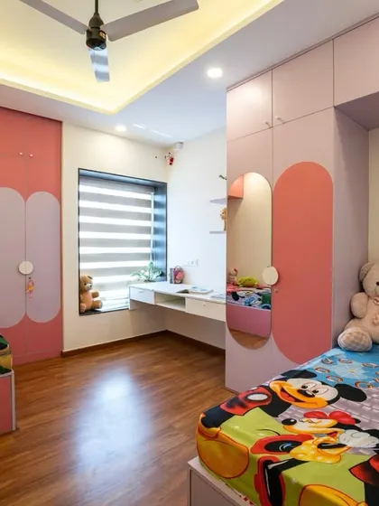 This view shows the clever layout of the shared room, with two beds, ample storage, and a cohesive color scheme that makes the space feel organized and fun.