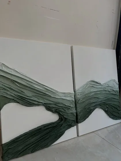 The complete diptych of the green fabric texture artwork. Placing the two canvases together creates a continuous flow, like rolling hills or gentle waves.