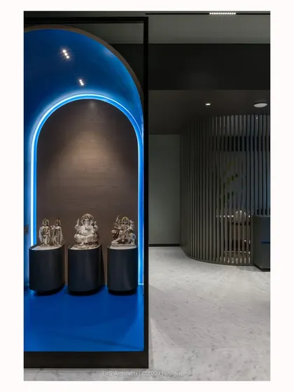 The family temple, conceptualized as an object in a frame, with a vibrant blue interior revealed through a strategic cut in its curved form.