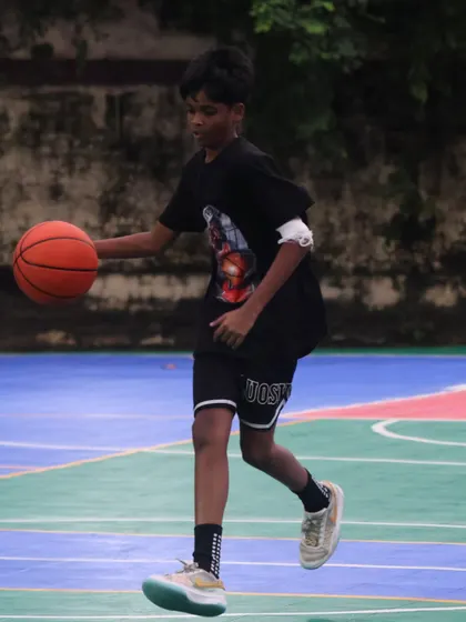 A young player dribbles confidently. We provide the training and community to help next-gen hoopers succeed.