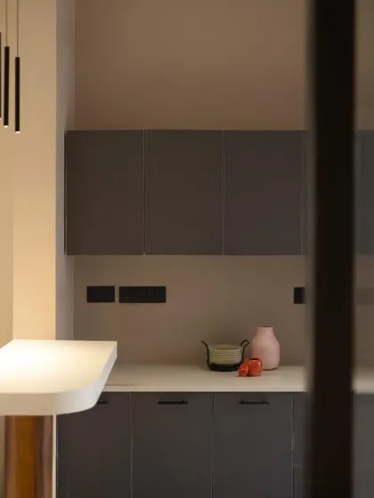 A detail view of the pantry corner, showing the simple yet elegant combination of materials and decorative elements.
