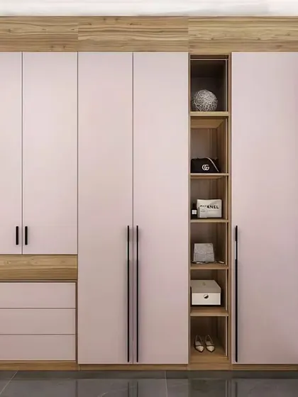 A stylish pink and wood-finish wardrobe with an integrated dressing table and open display shelves.