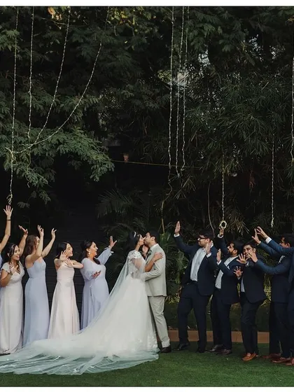 A magical moment with the bridesmaids. The bride shares a laugh with her girls under a canopy of fairy lights, their smiles illuminating the evening.