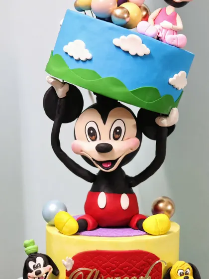 Another angle of the sculpted Mickey Mouse, showing the strength and balance required for this gravity-defying cake design.