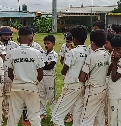 A coach gives a team talk to our U-12 and U-16 players during a break in play, providing strategic advice and motivation.