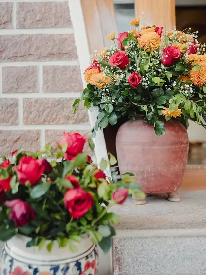 Floral arrangements in traditional pots.