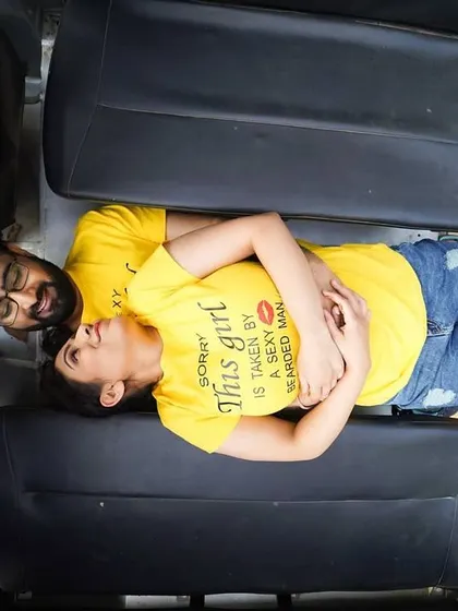 A unique overhead shot of a couple relaxing in the back of a jeep. This creative angle provides a different and interesting perspective for a pre-wedding photo.