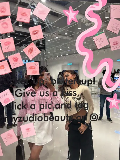 A mirror selfie with a friend at a fun event, with doodles to capture the memory.