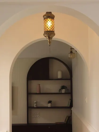 Embarking on a journey of craftsmanship. A beautiful double archway with a Moroccan-style pendant light, creating a grand and inviting entrance.