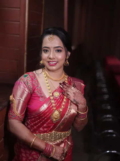 A close-up of the bride's happy face. The makeup is fresh and glowing, designed to last through a long day of celebrations.