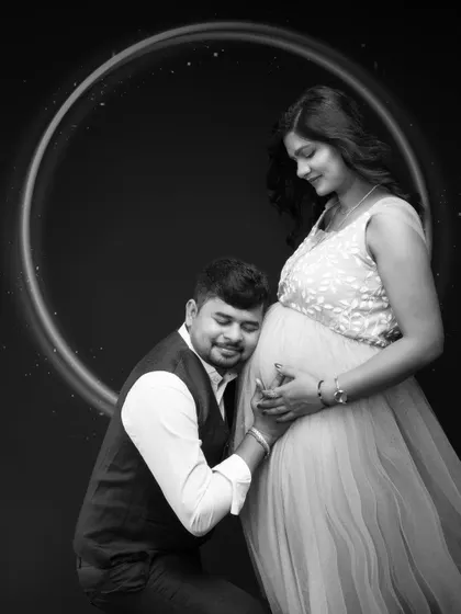 A moment to hold onto forever. This tender black and white portrait captures the bond between a couple on the verge of parenthood, with a soft glow that reflects their love.