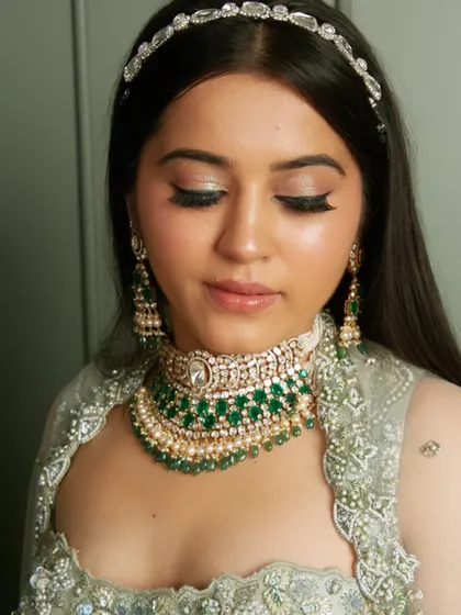 A glamorous reception look with a silver-green lehenga and a sparkling headband, created by one of my students.
