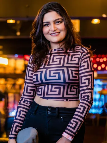 A guest posing in a patterned top.